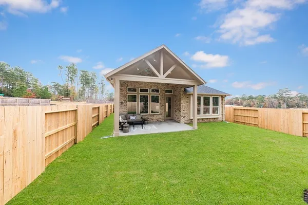a view of a house with a yard porch and sitting area