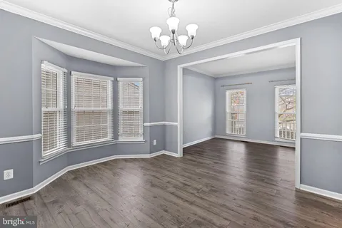 a kitchen with granite countertop a sink stove and refrigerator