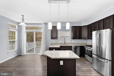 a kitchen with a sink a counter top space and appliances