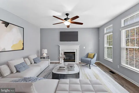 wooden floor fireplace and windows in an empty room