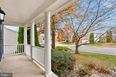a view of a hallway with wooden floor and entryway