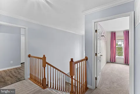 a spacious bedroom with a bed and wooden floor
