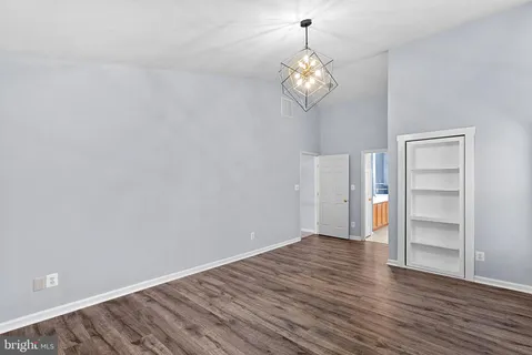 a bedroom with a bed and a dresser next to a window
