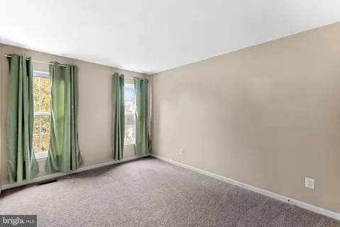 a view of a small space with wooden floor and a window