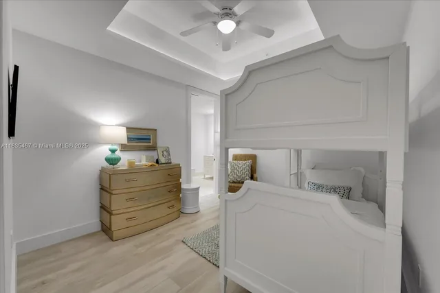 a bed room with a bed and a view of kitchen