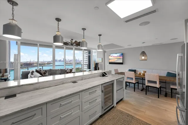 a large kitchen with a large counter top appliances and cabinets