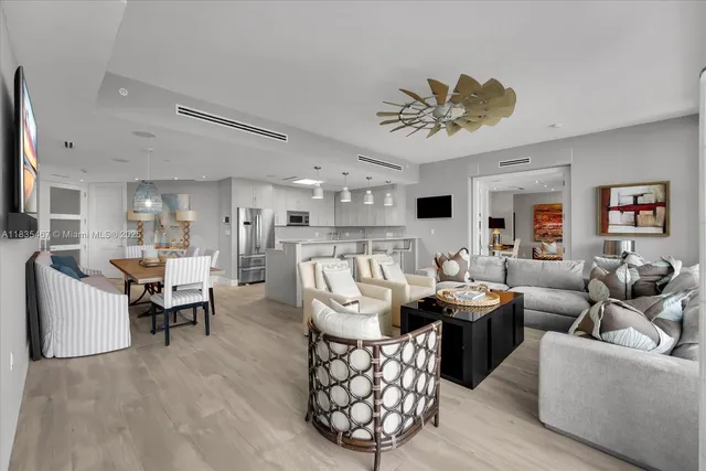 a living room with furniture or chandelier and a wooden floor