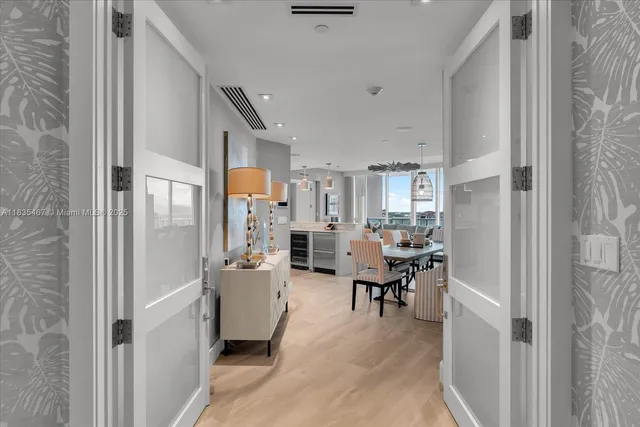 a kitchen with stainless steel appliances kitchen island granite countertop a refrigerator and a sink