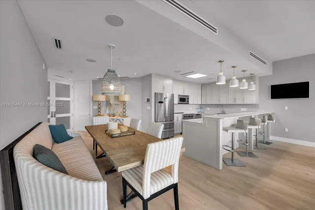 a dining room with furniture and wooden floor