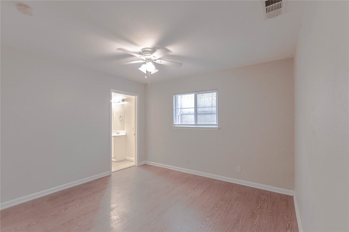 2005 Matthews Lane, Unit 2 Austin, TX 78745 - Photo 13 of 25 an empty room with windows and fan