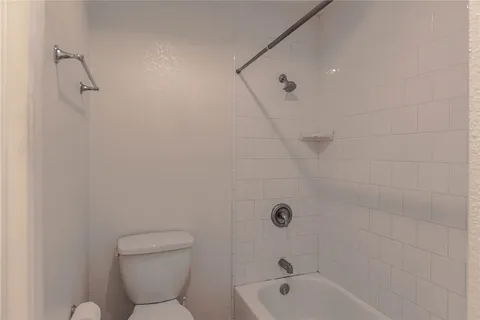 a bathroom with a toilet and a bathtub