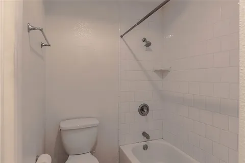 a bathroom with a toilet and a bathtub