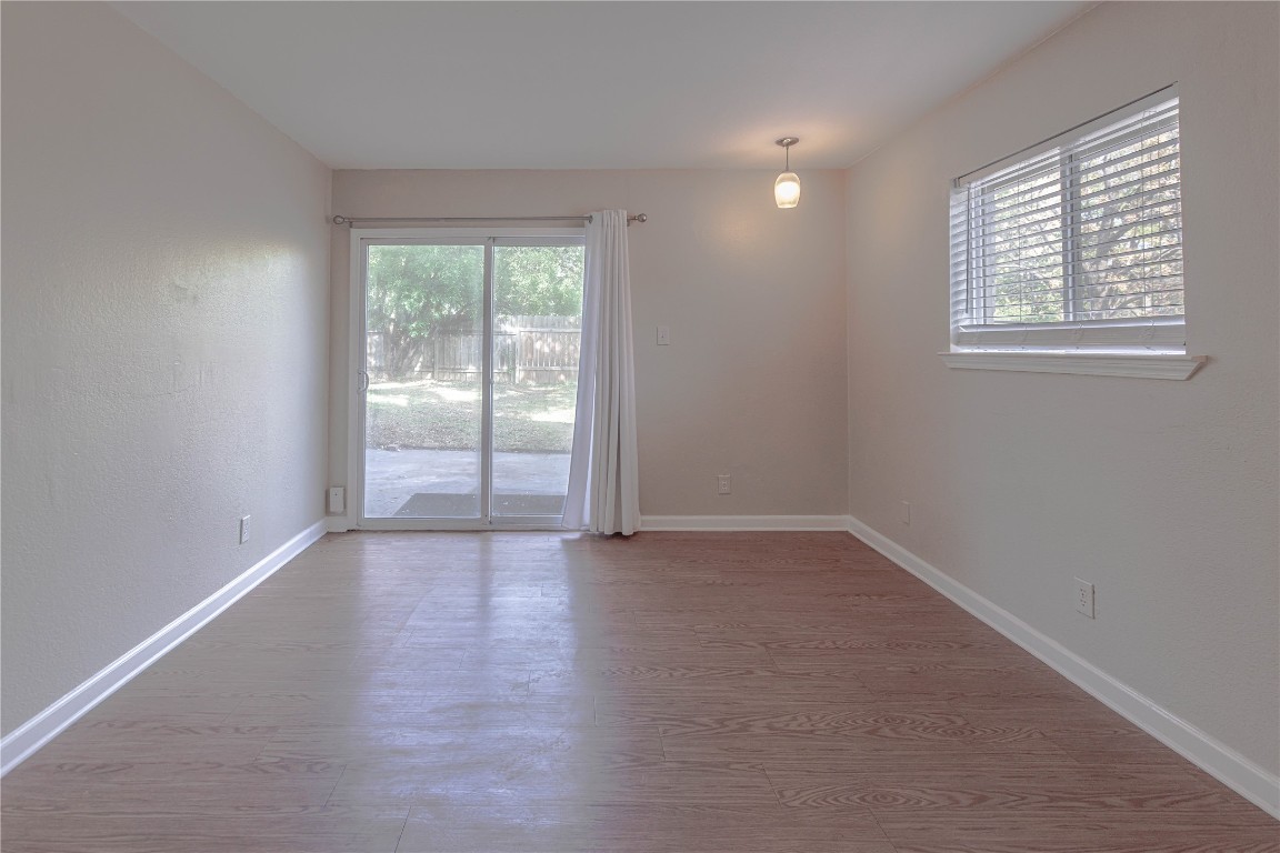 2005 Matthews Lane, Unit 2 Austin, TX 78745 - Photo 6 of 25 an empty room with wooden floor and windows