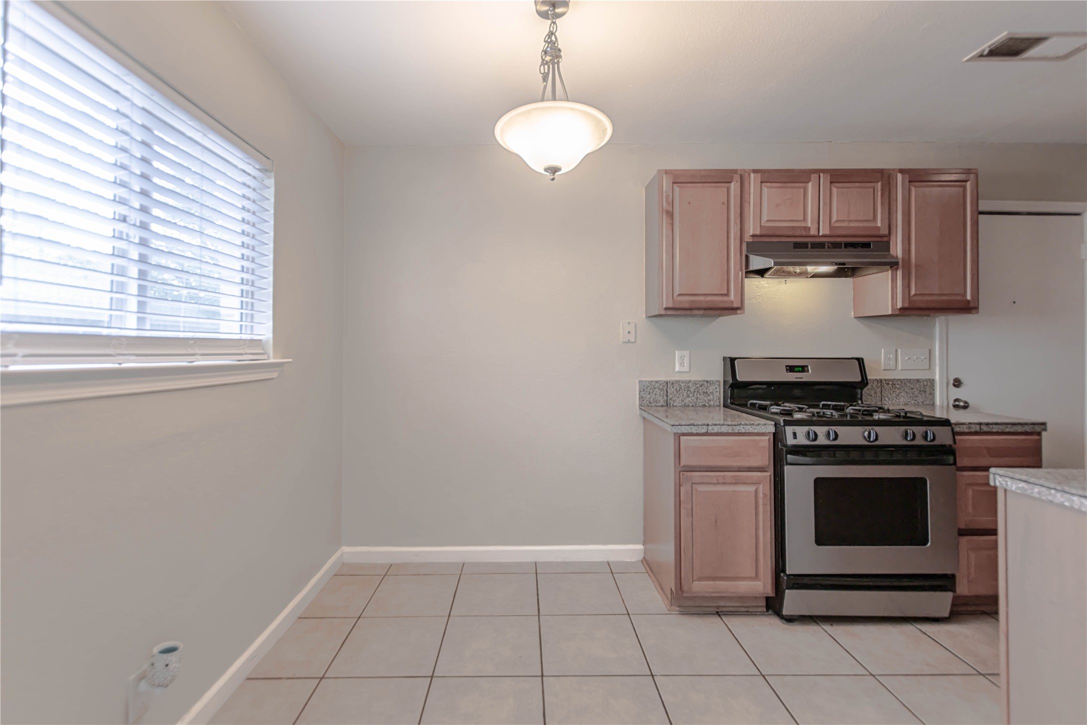 2005 Matthews Lane, Unit 2 Austin, TX 78745 - Photo 9 of 25 a kitchen with a stove and a microwave