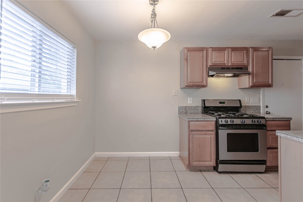 2005 Matthews Lane, Unit 2 Austin, TX 78745 - Photo 9 of 25 a kitchen with a stove and a microwave