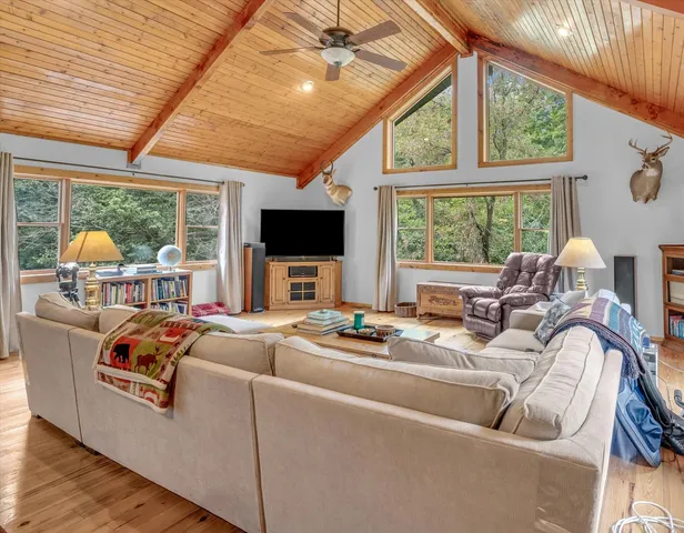 a kitchen with stainless steel appliances kitchen island granite countertop a refrigerator and cabinets