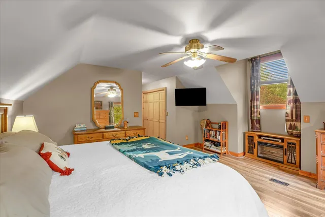 a bedroom with furniture and a flat screen tv