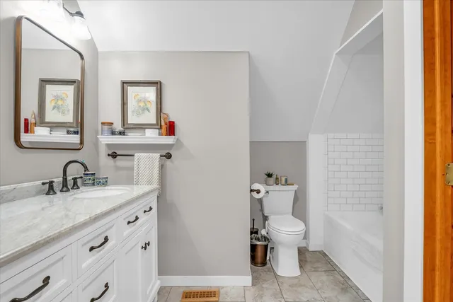 a view of a house with a yard and sitting area