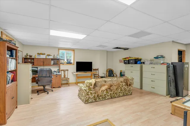 an aerial view of ocean and residential houses with outdoor space