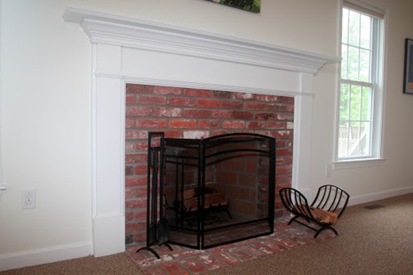 13 Clealand Circle Rutland, MA 01543 - Photo 11 of 30 a living room with a fireplace and a chair