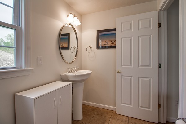 13 Clealand Circle Rutland, MA 01543 - Photo 15 of 30 a bathroom with a sink a mirror and a window