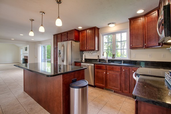 13 Clealand Circle Rutland, MA 01543 - Photo 5 of 30 a kitchen with stainless steel appliances granite countertop a refrigerator a sink dishwasher a stove and a sink with wooden cabinets