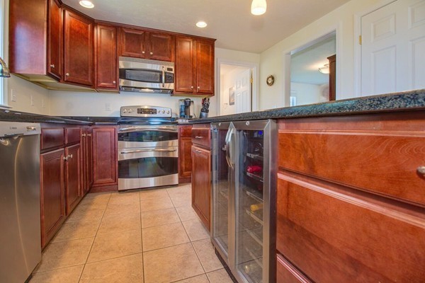 13 Clealand Circle Rutland, MA 01543 - Photo 7 of 30 a kitchen with stainless steel appliances granite countertop a refrigerator and a stove top oven