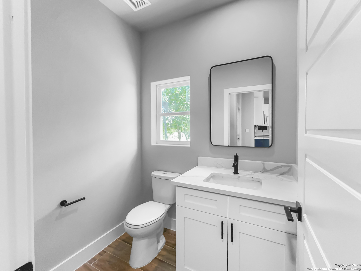 301 Hiram Cook Blanco, TX 78606 - Photo 14 of 16 a bathroom with a toilet sink and mirror