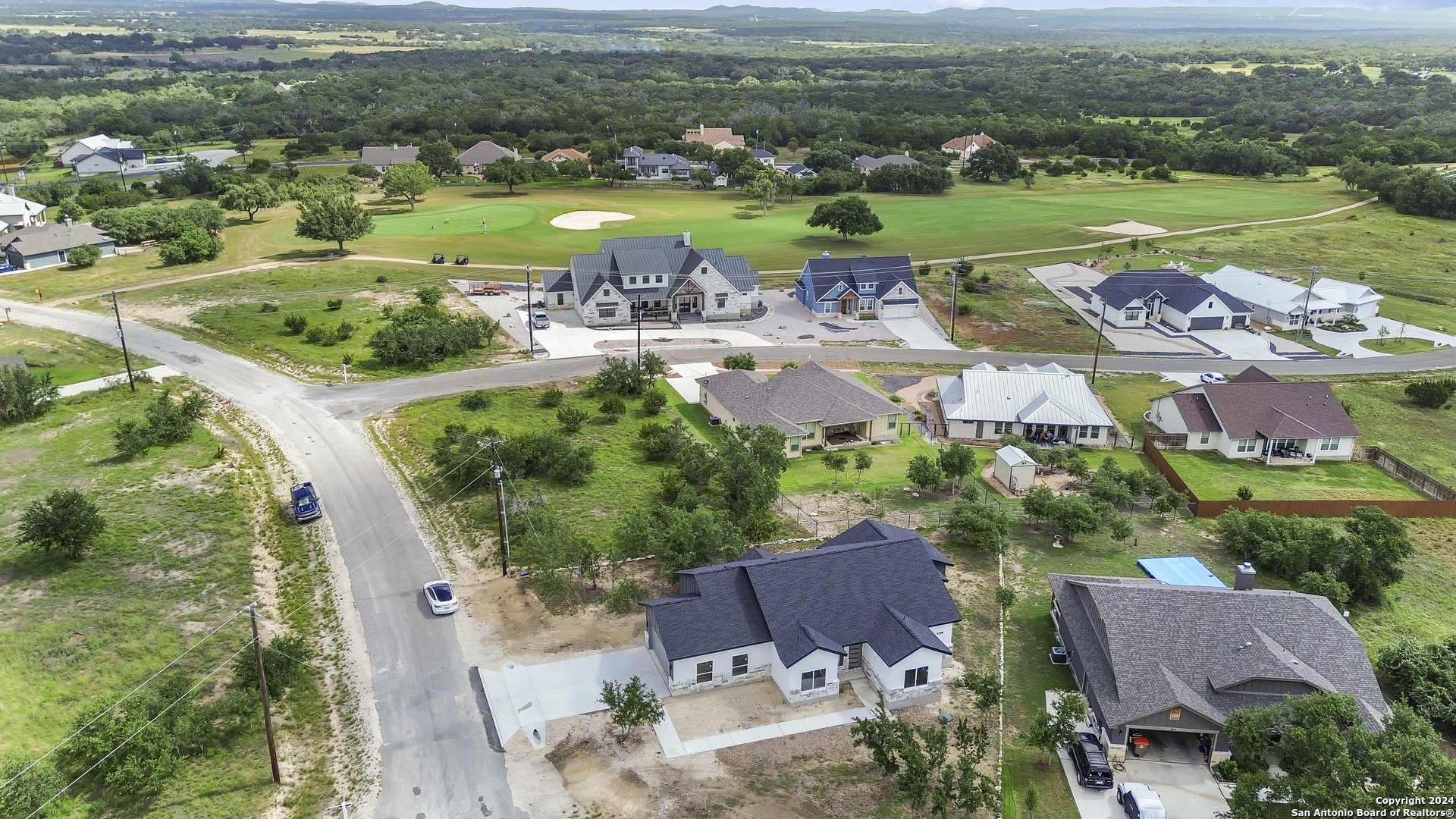 301 Hiram Cook Blanco, TX 78606 - Photo 3 of 16 an aerial view of a city with lots of residential buildings and mountain view in back