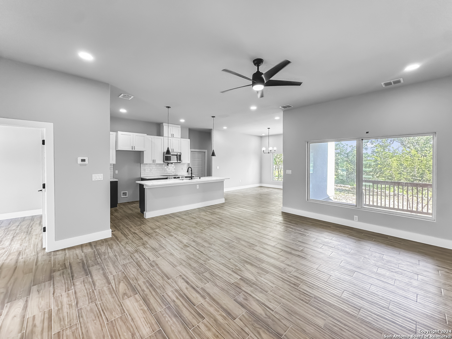 301 Hiram Cook Blanco, TX 78606 - Photo 4 of 16 a view of an empty room with wooden floor and a window