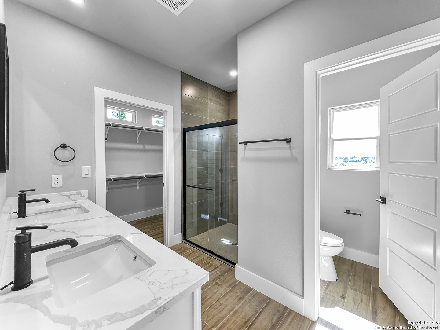 301 Hiram Cook Blanco, TX 78606 - Photo 9 of 16 a bathroom with a sink and mirror with toilet