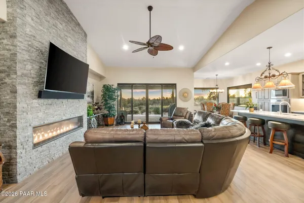 a kitchen with stainless steel appliances kitchen island granite countertop a refrigerator and a stove top oven