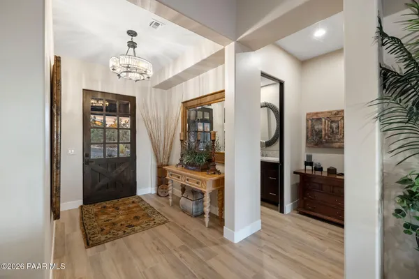 a living room with furniture and a floor to ceiling window