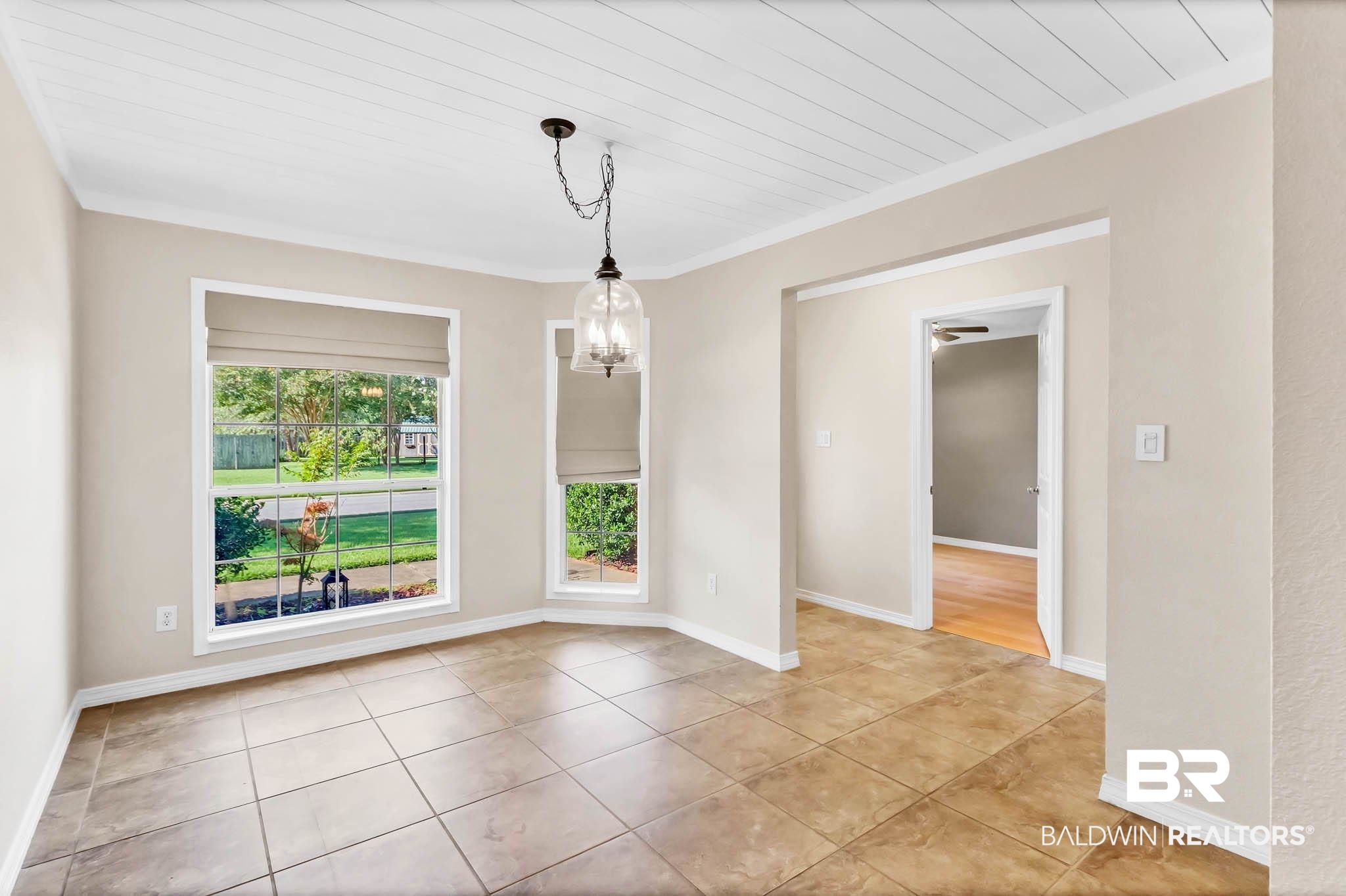 9607 Czar Court Fairhope, AL 36532 - Photo 16 of 42 Unfurnished dining area featuring a chandelier, crown molding, and light tile patterned floors