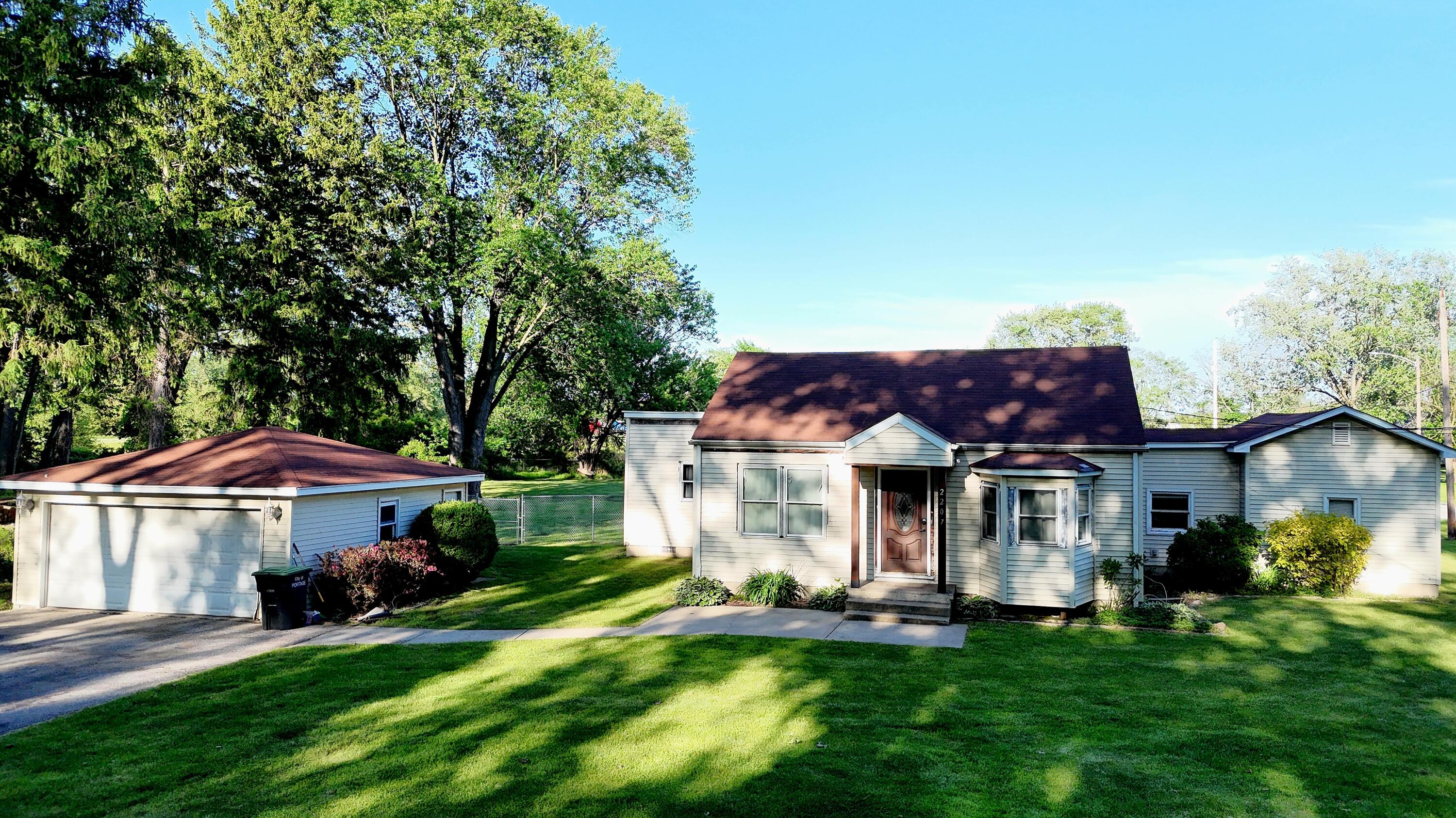 2207 North County Line Road Portage, IN 46368 - Photo 12 of 16 a front view of a house with a garden and deck