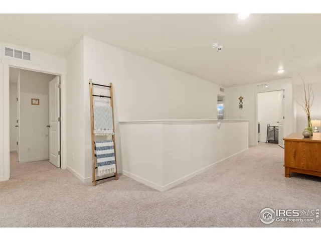 a spacious bedroom with a bed and a large window