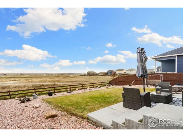 a view of a house with a big yard and large trees