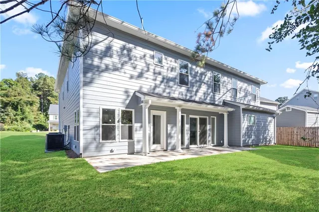 a front view of a house with swimming pool and porch with a table