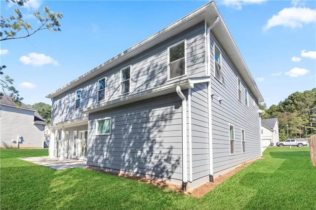 a front view of a house with a garden