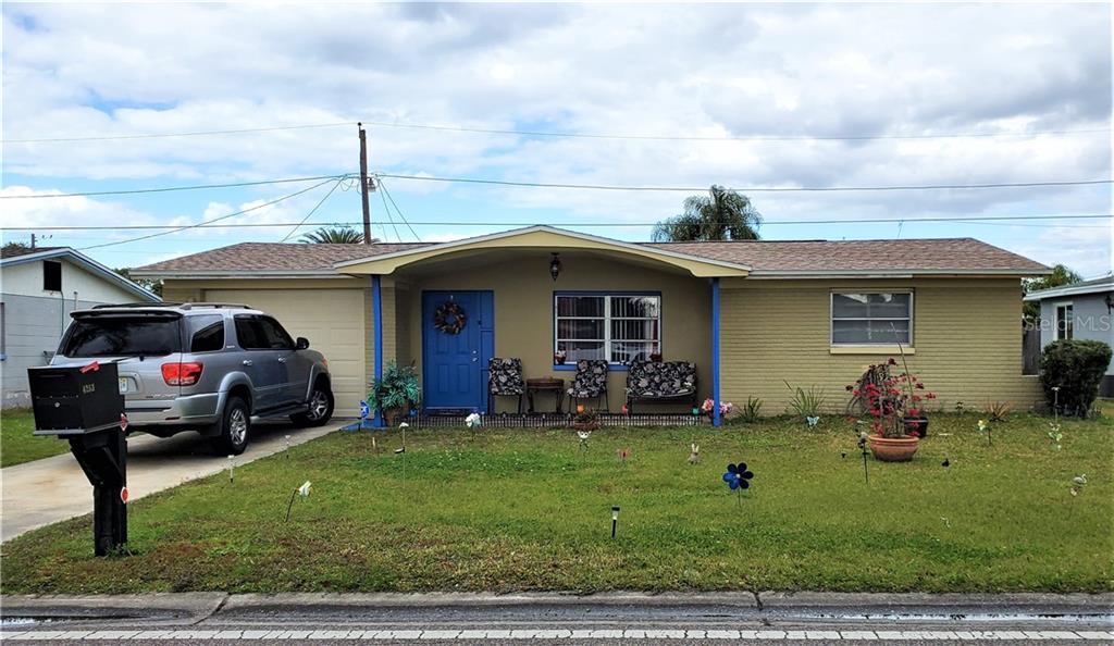 4253 Darlington Road Holiday, FL 34691 - Photo 1 of 1 a front view of a house with garden