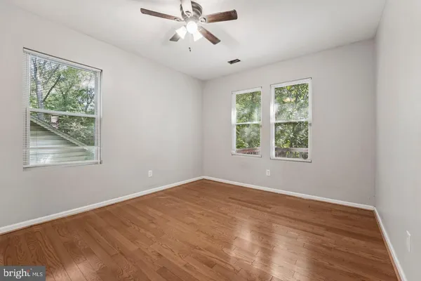wooden floor in an empty room with a window