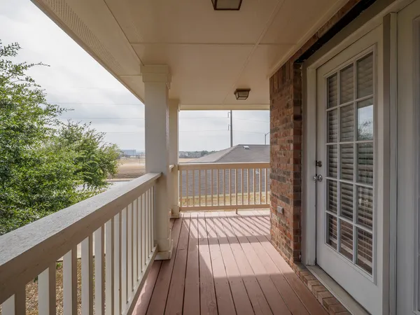 a view of balcony with wooden floor