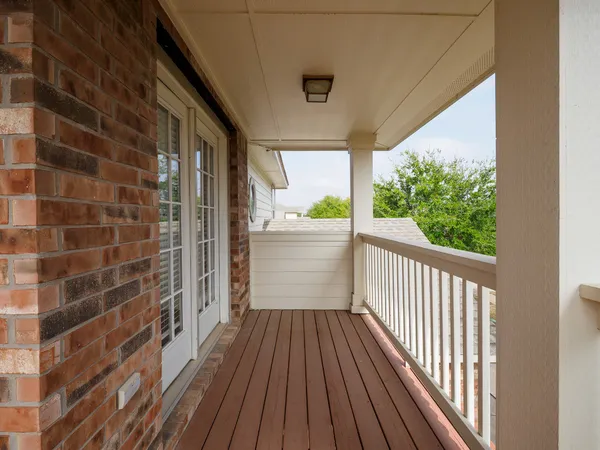 a view of a balcony with wooden floor