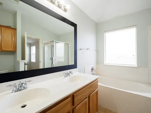 a bathroom with a sink a mirror and a bathtub