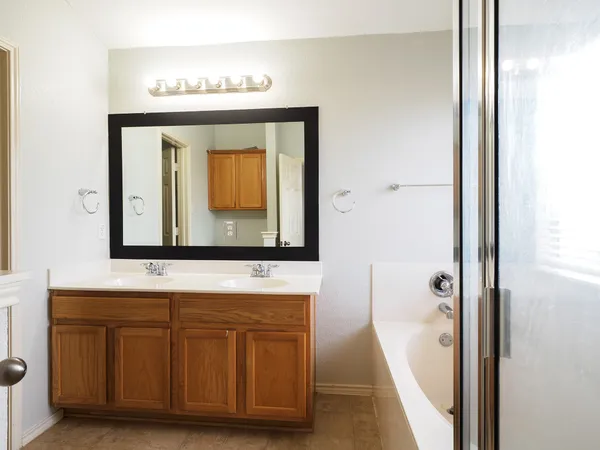 a bathroom with a sink a mirror and a bathtub