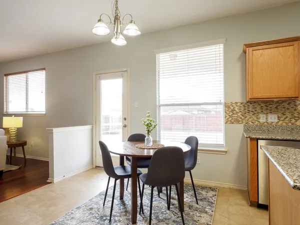 a dining room with wooden floor and a window