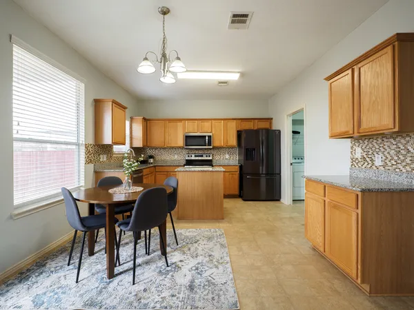 a view of a dining room with furniture and window