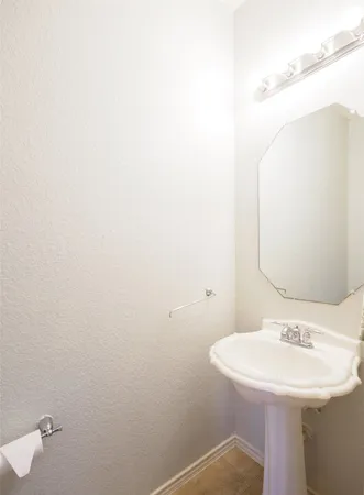 a bathroom with a sink and mirror