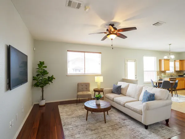 a living room with furniture a table and a potted plant