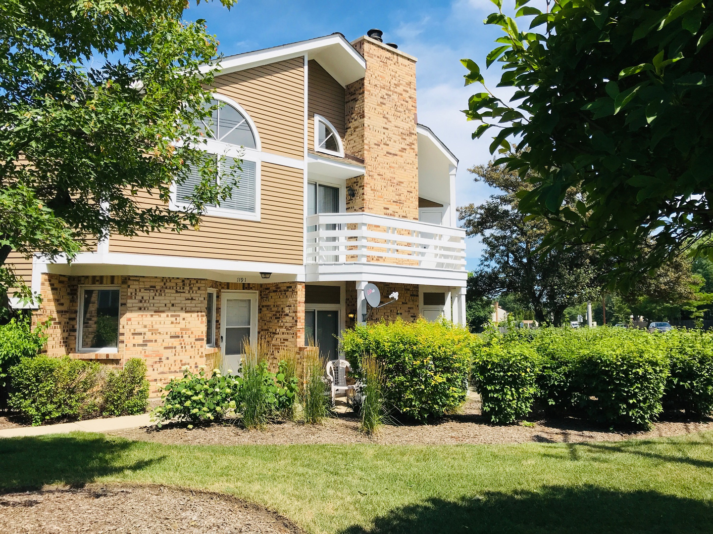 1191 Ranchview Court Buffalo Grove, IL 60089 - Photo 1 of 20 a front view of a house with a yard and potted plants